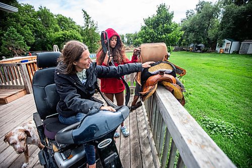 MIKAELA MACKENZIE / FREE PRESS

	
Alyssa Selman and her daughter, Ari Selman (13), show Alyssa&#x573; customized saddle (with the foam that she cut and added herself) at their property near Graysville on Thursday, Aug. 8, 2024.

For Mike McIntyre story.