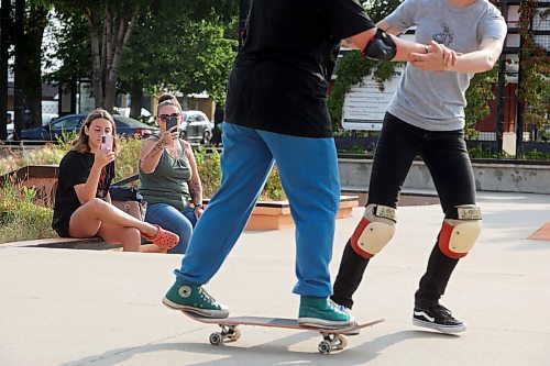 14082024
Friend Jacelyn Derlago and grandmother Deanna Nicholson watch as twelve-year-old Airianna Nicholson of Brandon learns how to skateboard with help from Jesi Wood during a week-long beginners skate camp put on by Recovery Skateshop at the Kristopher Campbell Memorial Skate Plaza. Recovery is running a similar camp for intermediate skateboarders next week. The recent Paris Olympics featured both men&#x2019;s and women&#x2019;s skateboarding events for the second time in Olympic history. (Tim Smith/The Brandon Sun)