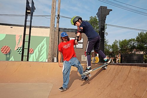 14082024
Recovery Skateshop owner Taber Collens helps ten-year-old Jace Shelbey of Shilo, Manitoba practice dropping in on a quarterpipe at the Kristopher Campbell Memorial Skate Plaza in downtown Brandon on Wednesday morning during a week-long beginners skate camp put on by Recovery Skateshop. Recovery is running a similar camp for intermediate skateboarders next week. The recent Paris Olympics featured both men&#x2019;s and women&#x2019;s skateboarding events for the second time in Olympic history. (Tim Smith/The Brandon Sun)