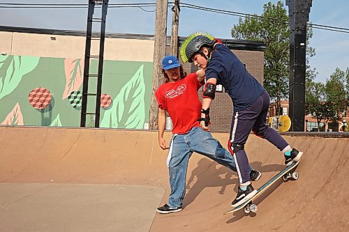 14082024
Recovery Skateshop owner Taber Collens helps ten-year-old Jace Shelbey of Shilo, Manitoba practice dropping in on a quarterpipe at the Kristopher Campbell Memorial Skate Plaza in downtown Brandon on Wednesday morning during a week-long beginners skate camp put on by Recovery Skateshop. Recovery is running a similar camp for intermediate skateboarders next week. The recent Paris Olympics featured both men&#x2019;s and women&#x2019;s skateboarding events for the second time in Olympic history. (Tim Smith/The Brandon Sun)