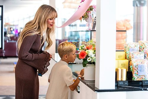 MIKAELA MACKENZIE / FREE PRESS

	
Ashley Kosowan and her son, seven-year-old Leo Kosowan, check out the baked goods display at the grand opening of Jenna Rae Cakes at the Winnipeg Richardson International Airport on Thursday, Aug. 15, 2024. 

Standup.