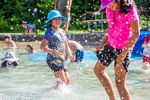 MIKAELA MACKENZIE / WINNIPEG FREE PRESS

Aurora (seven, left) and Eva (nine) Papagiannis splash in the wading pool at Valour Community Centre in Winnipeg on Wednesday, Aug. 10, 2022. It appears many wading pools are set to close by Aug. 19, which some complain is a few weeks ahead of schedule. For Joyanne story.
Winnipeg Free Press 2022.