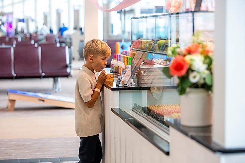 MIKAELA MACKENZIE / FREE PRESS

	
Seven-year-old Leo Kosowan checks out the baked goods display at the grand opening of Jenna Rae Cakes at the Winnipeg Richardson International Airport on Thursday, Aug. 15, 2024. 

Standup.