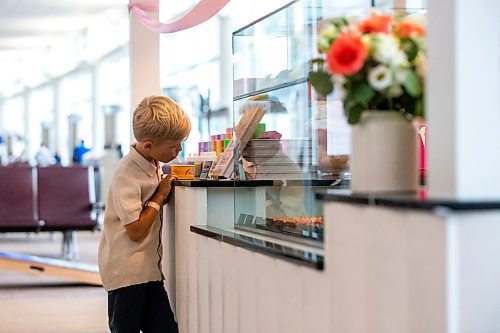 MIKAELA MACKENZIE / FREE PRESS

	
Seven-year-old Leo Kosowan checks out the baked goods display at the grand opening of Jenna Rae Cakes at the Winnipeg Richardson International Airport on Thursday, Aug. 15, 2024. 

Standup.