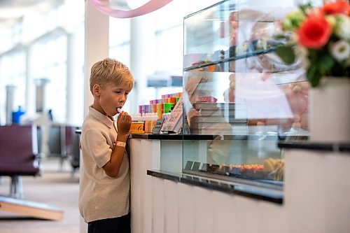 MIKAELA MACKENZIE / FREE PRESS

	
Seven-year-old Leo Kosowan checks out the baked goods display at the grand opening of Jenna Rae Cakes at the Winnipeg Richardson International Airport on Thursday, Aug. 15, 2024. 

Standup.