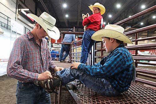 15082024
Carter Rosvold helps Lennon Ameel with his boots on day one of the Virden Indoor High School Rodeo at Tundra Oil and Gas Place in Virden on Thursday as part of the Virden Indoor Rodeo and Wild West Daze.
(Tim Smith/The Brandon Sun)