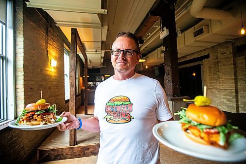 MIKAELA MACKENZIE / FREE PRESS

	
Shaun Jeffrey, executive director of the Manitoba Restaurant and Foodservices Association (MRFA), with the &#x492;aising Cain&#x4e0;chicken burger at The Saddlery on Thursday, Aug. 15, 2024. The MRFA is hosting its first local burger week, called Between the Buns. 

For Gabby story.