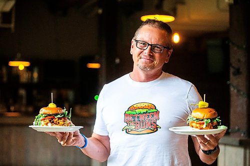 MIKAELA MACKENZIE / FREE PRESS

	
Shaun Jeffrey, executive director of the Manitoba Restaurant and Foodservices Association (MRFA), with the &#x492;aising Cain&#x4e0;chicken burger at The Saddlery on Thursday, Aug. 15, 2024. The MRFA is hosting its first local burger week, called Between the Buns. 

For Gabby story.