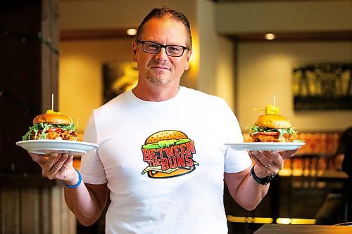 MIKAELA MACKENZIE / FREE PRESS

	
Shaun Jeffrey, executive director of the Manitoba Restaurant and Foodservices Association (MRFA), with the &#x492;aising Cain&#x4e0;chicken burger at The Saddlery on Thursday, Aug. 15, 2024. The MRFA is hosting its first local burger week, called Between the Buns. 

For Gabby story.