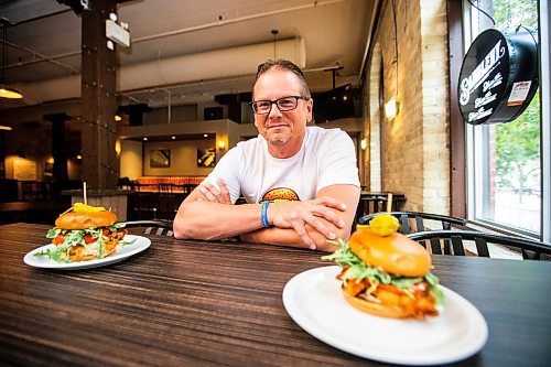 MIKAELA MACKENZIE / FREE PRESS

	
Shaun Jeffrey, executive director of the Manitoba Restaurant and Foodservices Association (MRFA), with the &#x492;aising Cain&#x4e0;chicken burger at The Saddlery on Thursday, Aug. 15, 2024. The MRFA is hosting its first local burger week, called Between the Buns. 

For Gabby story.