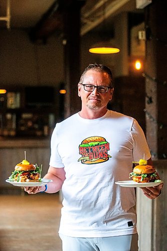 MIKAELA MACKENZIE / FREE PRESS

	
Shaun Jeffrey, executive director of the Manitoba Restaurant and Foodservices Association (MRFA), with the &#x492;aising Cain&#x4e0;chicken burger at The Saddlery on Thursday, Aug. 15, 2024. The MRFA is hosting its first local burger week, called Between the Buns. 

For Gabby story.