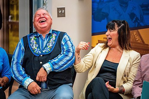 NIC ADAM / FREE PRESS
David Chartrand (left), President of the MMF, jokes with Bernadette Smith, Minister of housing addictions and homelessness, at the announcement of the re-opening of Yoga Public Thursday afternoon.
240815 - Thursday, August 15, 2024.

Reporter: Gabby Piche