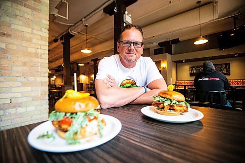 MIKAELA MACKENZIE / FREE PRESS

	
Shaun Jeffrey, executive director of the Manitoba Restaurant and Foodservices Association (MRFA), with the &#x492;aising Cain&#x4e0;chicken burger at The Saddlery on Thursday, Aug. 15, 2024. The MRFA is hosting its first local burger week, called Between the Buns. 

For Gabby story.