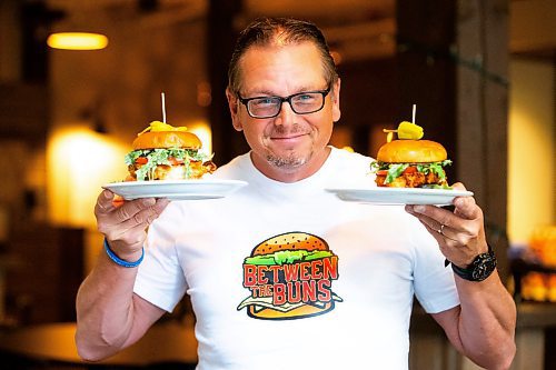 MIKAELA MACKENZIE / FREE PRESS

	
Shaun Jeffrey, executive director of the Manitoba Restaurant and Foodservices Association (MRFA), with the &#x492;aising Cain&#x4e0;chicken burger at The Saddlery on Thursday, Aug. 15, 2024. The MRFA is hosting its first local burger week, called Between the Buns. 

For Gabby story.