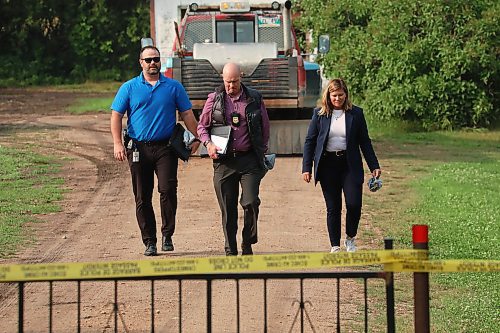 RCMP investigators walk on a rural property southeast of McCreary where three bodies were discovered earlier in the day on Friday. See story on page A3. (Tim Smith/The Brandon Sun)