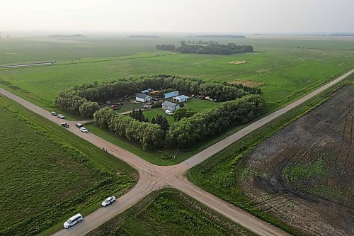 An aerial view of the rural property southeast of McCreary on Friday, with RCMP vehicles parked on the road and police tape surrounding the tree belt. (Tim Smith/The Brandon Sun)