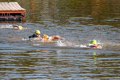 BROOK JONES / FREE PRESS
Jonathan Courchene (left), who is a First Nations triathlete, follows 15-year-old Phoenix Abraham (middle) and 17-year-old Brad Courchene (right) as they compete in the swim portion of the Free Spirit Sprint Triathlon in Pinawa, Man., Sunday, Aug. 11, 2024. Courchene has been coaching both youth in the sport of triathlon.