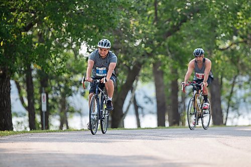 BROOK JONES / FREE PRESS
Fifteen-year-old Phoenix Abraham (left), who is from Sagkeeng First Nation, and Jonathan Courchene, who is a First Nations triathlete, compete in the bike portion of the Free Spirit Sprint Triathlon in Pinawa, Man., Sunday, Aug. 11, 2024. Courchene has been coaching Abraham in the sport of triathlon.