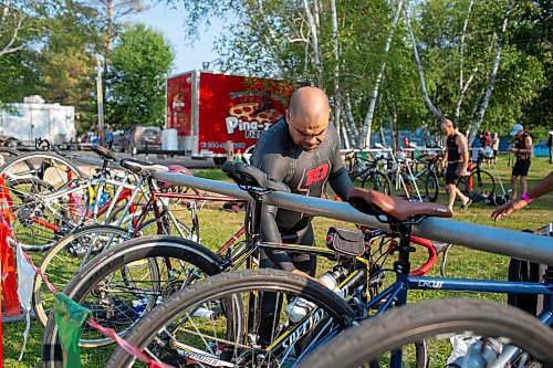 BROOK JONES / FREE PRESS
Jonathan Courchene who is First Nations triathlete is pictured putting a water bottle in its cage on his bike as he stands in the transition zone before the start of the Free Spirit Sprint Triathlon in Pinawa, Man., Sunday, Aug. 11, 2024.