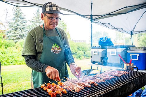 NIC ADAM / FREE PRESS
Leonardo Jonson, of K.A Guiao Inihaw Piony Street Foods, makes pork bbq for customers at Winnipeg&#x2019;s Streat Feast Festival at the Forks Friday afternoon.
240816 - Friday, August 16, 2024.

Reporter: ?