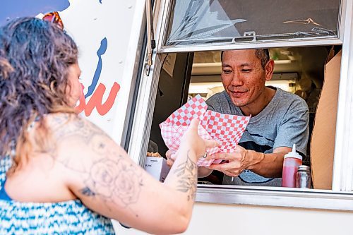 NIC ADAM / FREE PRESS
Harvard Sung, owner of the Wagu Wagon food truck, serves customers at Winnipeg&#x2019;s Streat Feast Festival at the Forks Friday afternoon. He&#x2019;s been running his food truck since May.
240816 - Friday, August 16, 2024.

Reporter: ?