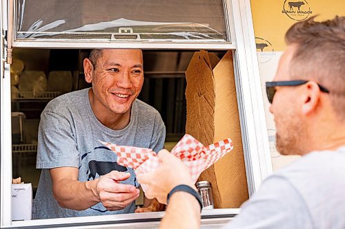 NIC ADAM / FREE PRESS
Harvard Sung, owner of the Wagu Wagon food truck, serves customers at Winnipeg&#x2019;s Streat Feast Festival at the Forks Friday afternoon. He&#x2019;s been running his food truck since May.
240816 - Friday, August 16, 2024.

Reporter: ?