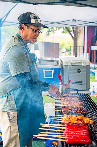 NIC ADAM / FREE PRESS
Leonardo Jonson, of K.A Guiao Inihaw Piony Street Foods, makes pork bbq for customers at Winnipeg&#x2019;s Streat Feast Festival at the Forks Friday afternoon.
240816 - Friday, August 16, 2024.

Reporter: ?