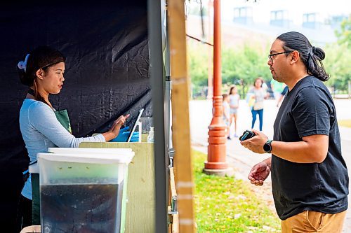 NIC ADAM / FREE PRESS
Nicole Chavez, of K.A Guiao Inihaw Piony Street Foods, serves up a plate of pork bbq to customers at Winnipeg&#x2019;s Streat Feast Festival at the Forks Friday afternoon.
240816 - Friday, August 16, 2024.

Reporter: ?