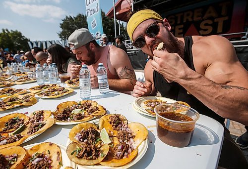 JOHN WOODS / WINNIPEG FREE PRESS
Josh, right, competes by eating 30 tacos at the Birria Battle Eating Competion during Streat Feast at the Forks in Winnipeg Sunday, August 18, 2024.

Re: ?