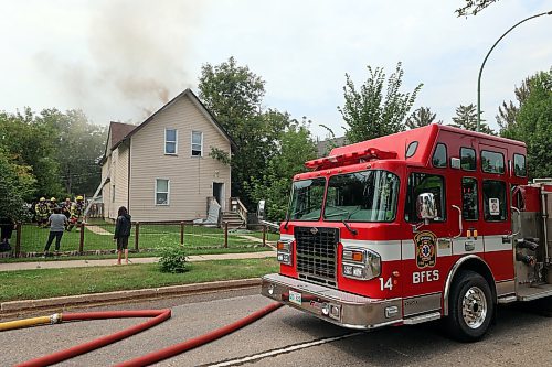 Firefighters tackle a house fire on the 200 block of First Street on Sunday afternoon. On Monday, Brandon Police Service said they're investigating whether the fire was caused by squatters setting a campfire next to the home's fence. (Colin Slark/The Brandon Sun)