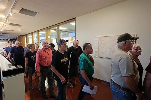 Residents on the second floor of Brandon City Hall look for other places to sit or stand after council chambers were filled to capacity ahead of a scheduled public hearing on the new proposed city plan. (Colin Slark/The Brandon Sun)