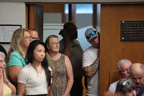 Attendees at a public hearing on the proposed new city plan at Monday's Brandon City Council meeting peer through the door with all the seats in the room filled. (Colin Slark/The Brandon Sun)