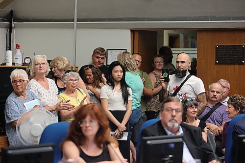 Attendees at a public hearing on the proposed new city plan at Monday's Brandon City Council meeting peer through the door with all the seats in the room filled. (Colin Slark/The Brandon Sun)