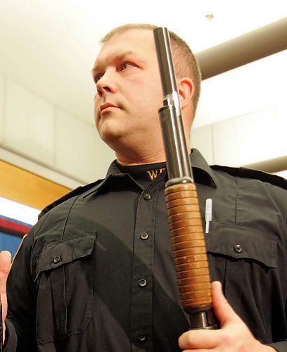 WAYNE GLOWACKI/WINNIPEG FREE PRESS  At a news conference Winnipeg Police  Const. Jeff Norman with two shotguns, one with the barrel shortened and the other with the gun stock cut. The  weapons were seized in the  300 block of Inkster Blvd. along with 3.5 grams of crack cocaine and cash. Bruce Owen has story   Jan 11 2008