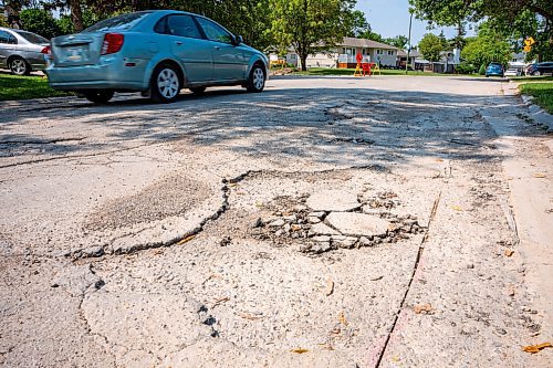 NIC ADAM / FREE PRESS
After a long wait, pothole repairs finally commence along Augusta Dr. Monday.
240819 - Monday, August 19, 2024.

Reporter:?