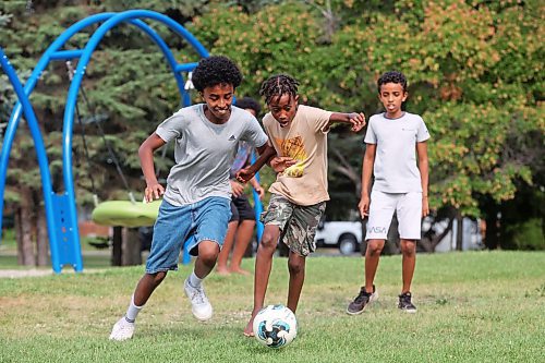 19082024
Abdi Eshetu and Merken Zerilasie battle for the ball while playing soccer with friends at Rideau Park on a sunny Monday afternoon. (Tim Smith/The Brandon Sun)