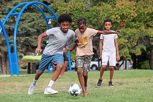 19082024
Abdi Eshetu and Merken Zerilasie battle for the ball while playing soccer with friends at Rideau Park on a sunny Monday afternoon. (Tim Smith/The Brandon Sun)