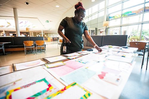 MIKAELA MACKENZIE / WINNIPEG FREE PRESS
	
Nurse Mercy Yusuf takes a look at items that will fill a time capsule remembering the COVID-19 pandemic and the healthcare workers that held steadfast during that time at the St. Boniface Hospital on Tuesday, Aug. 20, 2024.

Winnipeg Free Press 2024