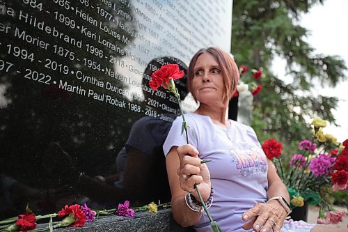 Ruth Bonneville /Free Press

Local - MADD Memorial photo
 
Photo of  Krista Brown holding a red flower next to the name of her partner, Martin Paul Robak, on the monument. Her partner&#x2019;s name was added on the weekend.

The MADD Manitoba Memorial Monument is located at Glen Eden Funeral Home and Cemetary 4477 Main Street West St. Paul.

Who: Krista Brown, partner of Martin Paul Robak who was killed by a drunk driver. 

Reporter: Jura

Aug 20, 2024