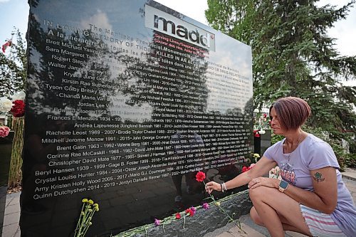 Ruth Bonneville /Free Press

Local - MADD Memorial photo
 
Photo of  Krista Brown holding a red flower next to the name of her partner, Martin Paul Robak, on the monument. Her partner&#x2019;s name was added on the weekend.

The MADD Manitoba Memorial Monument is located at Glen Eden Funeral Home and Cemetary 4477 Main Street West St. Paul.

Who: Krista Brown, partner of Martin Paul Robak who was killed by a drunk driver. 

Reporter: Jura

Aug 20, 2024