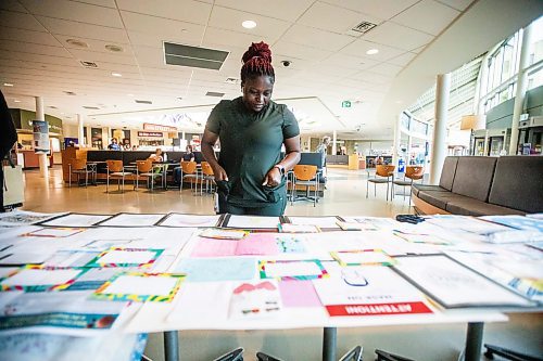 MIKAELA MACKENZIE / WINNIPEG FREE PRESS
	
Nurse Mercy Yusuf takes a look at items that will fill a time capsule remembering the COVID-19 pandemic and the healthcare workers that held steadfast during that time at the St. Boniface Hospital on Tuesday, Aug. 20, 2024.

Winnipeg Free Press 2024