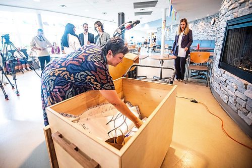 MIKAELA MACKENZIE / WINNIPEG FREE PRESS
	
St. Boniface Hospital Foundation president and CEO Karen Fowler places items into a time capsule remembering the COVID-19 pandemic and the healthcare workers that held steadfast during that time at the St. Boniface Hospital on Tuesday, Aug. 20, 2024.

Winnipeg Free Press 2024