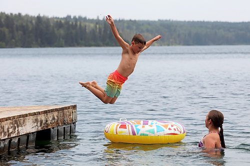 20082024
Bennett Davies of Brandon leaps off the dock into Clear Lake as his sister Bethany swims with a tube at Deep Bay in Riding Mountain National Park on an overcast and hot Tuesday afternoon.
(Tim Smith/The Brandon Sun)