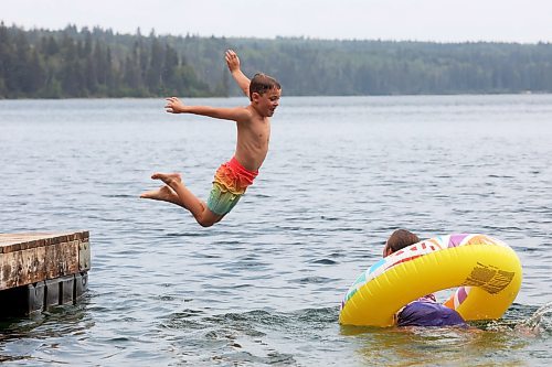 20082024
Bennett Davies of Brandon leaps off the dock into Clear Lake as his sister Bethany swims with a tube at Deep Bay in Riding Mountain National Park on an overcast and hot Tuesday afternoon.
(Tim Smith/The Brandon Sun)