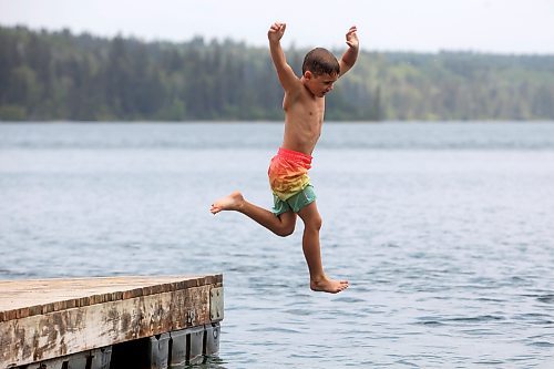 20082024
Bennett Davies of Brandon leaps off the dock into Clear Lake at Deep Bay in Riding Mountain National Park on an overcast and hot Tuesday afternoon.
(Tim Smith/The Brandon Sun)