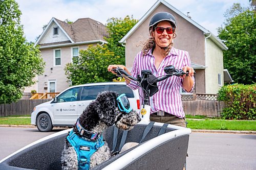 NIC ADAM / FREE PRESS
Cyclist Julia Schroeder rides her cargo bike along Annabella St. Wednesday with her dog Willow. She will be participating in Thursday&#x2019;s group ride.
240821 - Wednesday, August 21, 2024.

Reporter: Joyanne