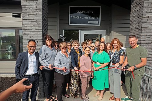 Members of the Expanding Community Cancer Care Committee, cancer patients and dignitaries cut the ribbon during the grand opening of the Community Cancer Care Centre in Russell on Wednesday. (Tim Smith/The Brandon Sun)