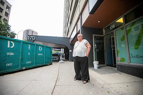 MIKAELA MACKENZIE / WINNIPEG FREE PRESS
	
Meals on Wheels executive director Marla Somersall outside of their office, which has industrial fans and dehumidifiers drying it out, after a flood damaged the Holiday Towers building in downtown Winnipeg on Wednesday, Aug. 21, 2024.

For Nicole story.
Winnipeg Free Press 2024