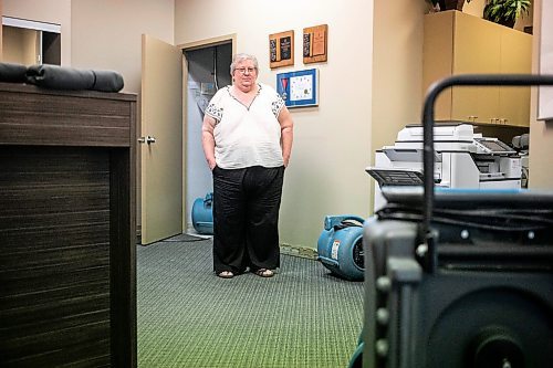 MIKAELA MACKENZIE / WINNIPEG FREE PRESS
	
Meals on Wheels executive director Marla Somersall in their office, which has industrial fans and dehumidifiers drying it out, after a flood damaged the Holiday Towers building in downtown Winnipeg on Wednesday, Aug. 21, 2024.

For Nicole story.
Winnipeg Free Press 2024