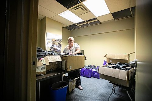 MIKAELA MACKENZIE / WINNIPEG FREE PRESS
	
Meals on Wheels executive director Marla Somersall with a couple of hundred volunteer jackets (that were protected from water) in their office, which has industrial fans and dehumidifiers drying it out, after a flood damaged the Holiday Towers building in downtown Winnipeg on Wednesday, Aug. 21, 2024.

For Nicole story.
Winnipeg Free Press 2024